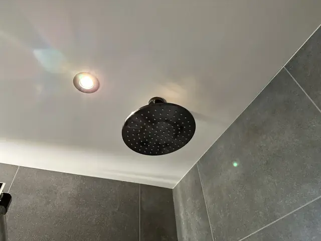 Badkamer in betonlook met verlichte spiegel, foto 7 van 10